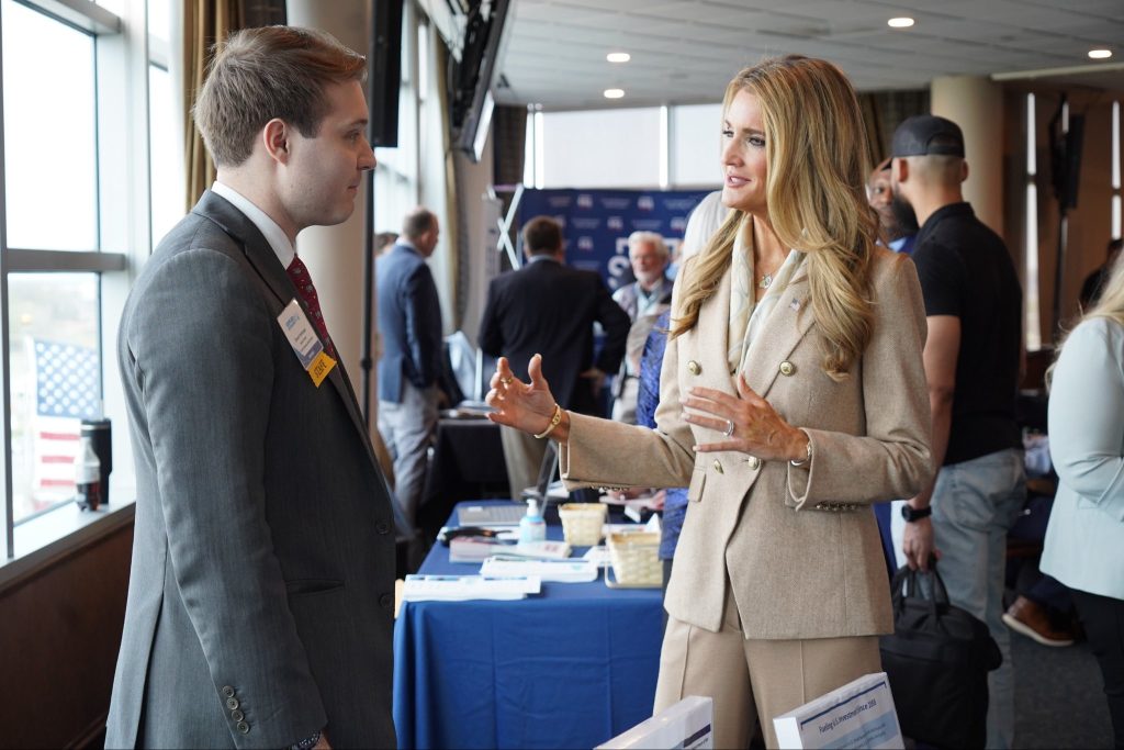 Administrator Loeffler speaks to a staffer at an SBA related event
